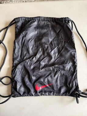 Nike Black Drawstring Backpack with Red Swoosh Logo